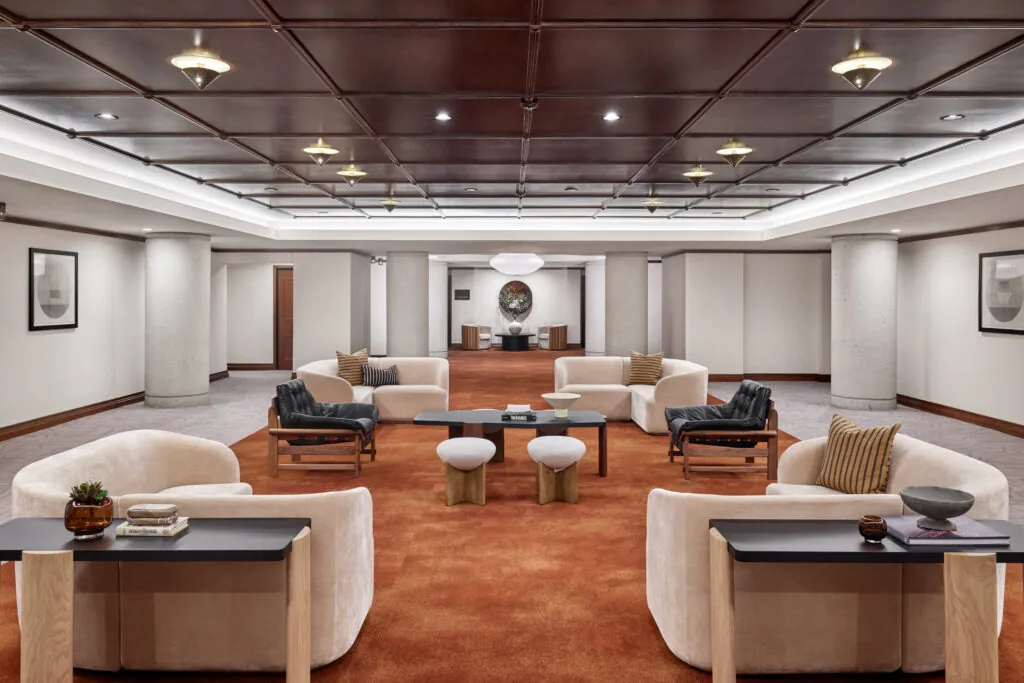 Lounge area with modern seating and a decorative wall.